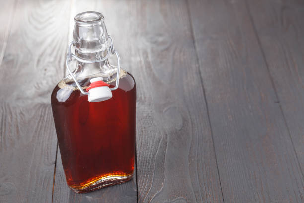 istock Homemade alcohol cordial drink in bottle on table 974185592