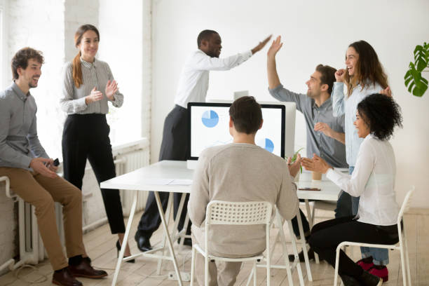istock Excited multiracial team celebrating shared online contract win 974191822