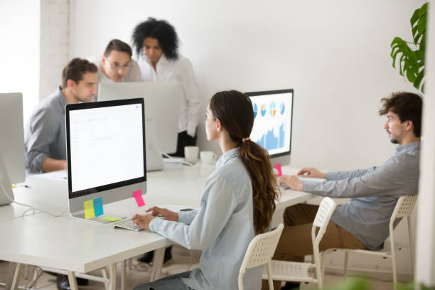 istock Focused female worker writing business email at pc 974191866