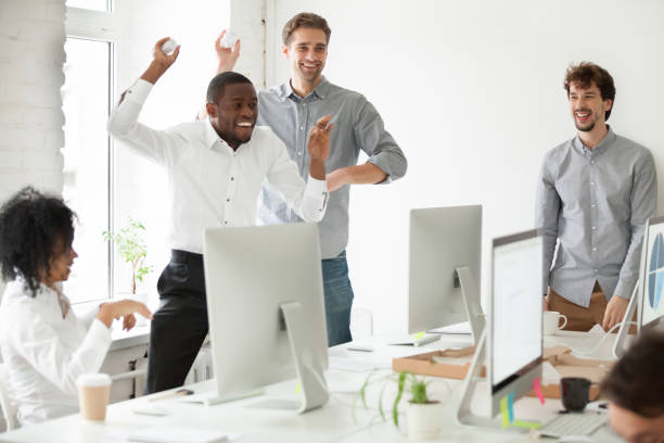 istock Positive multiracial team having fun throwing paper balls 974192046