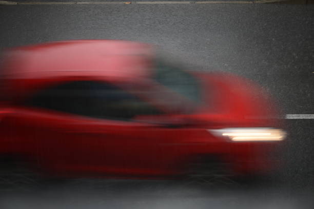 istock cars run on the road during a downpour 974196310