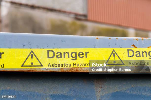Warning Tape Across A Bin At An Asbestos Cleanup Stock Photo - Download Image Now - Asbestos, Removing, Warning Symbol
