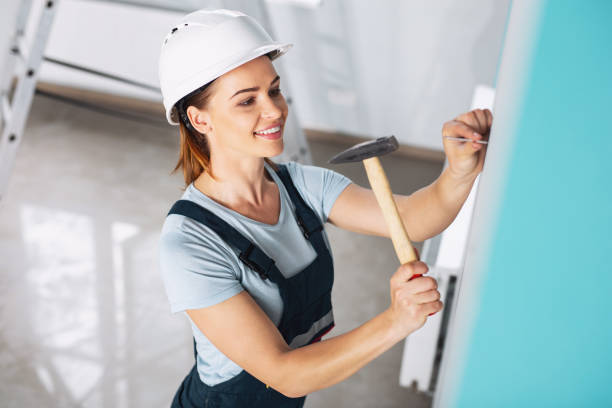 istock Inspired female builder hammering a nail 974196538