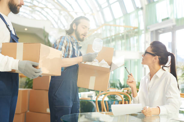 istock Restaurant manager taking delivery of wineglasses 974198188