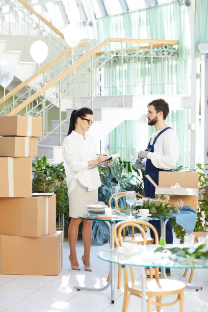 istock Business lady asking mover about delivery order 974198206