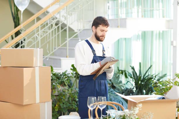 istock Moving company foreman writing information about delivery 974198214
