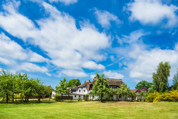 Buildings, trees and clouds in Wiek, Germany.