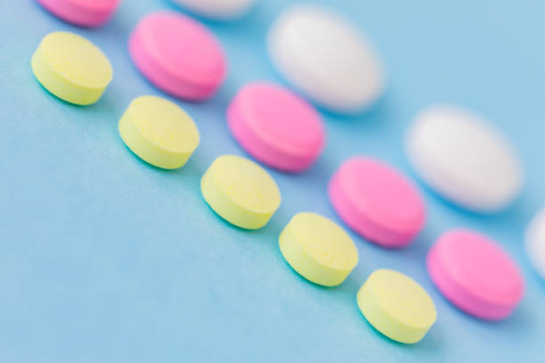 istock Medication, colourful pills, flat lay on blue background 974202354