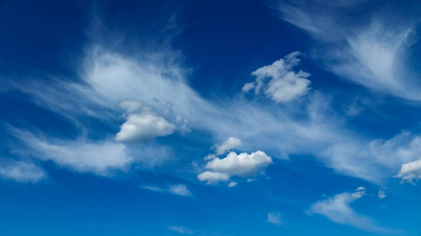 Low pressure weather front system approaching on blue sky stock photo