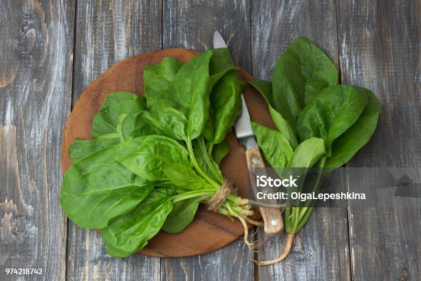 Bunch Of Fresh Spinach With Roots On A Wooden Table Stock Photo - Download Image Now