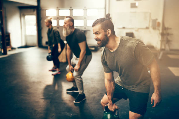istock Fit people working out with weights at the gym 974232638