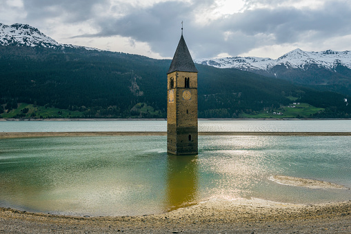 Church under water, drowned village, mountains landscape and peaks in background. Reschensee Lake Reschen Lago di Resia. Italy, Europe, Südtirol, South Tyrol, Upper Adige, Alto Adige,no logos,Nikon D850