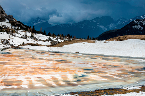 View of Lake Valparola in the spring in dirty snow, Falzarego,Dolomites, European Alps, Italy,no logos,Nikon D850
