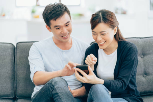 istock Young asian couple with smartphone 974241730