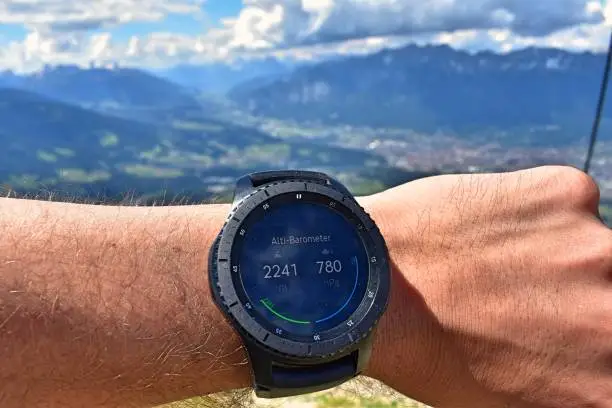 Demonstrating how a smartwatch can be used to show your altitude while hiking in the mountains