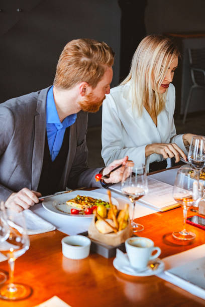 istock Group of Friends Having a Conversation During Lunch Time in a Cafe / Restaurant 974256730