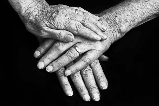 istock Helping protective hands of an old couple 974260024