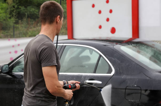 istock Man washing car outdoors 974260822