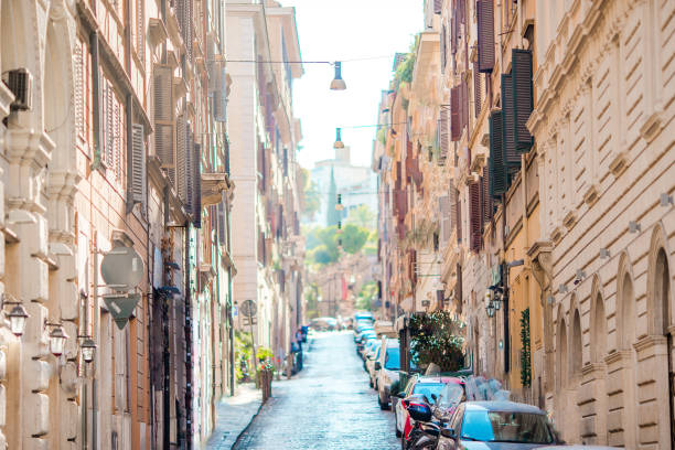 istock Old beautiful empty streets with cars in Rome 974263506