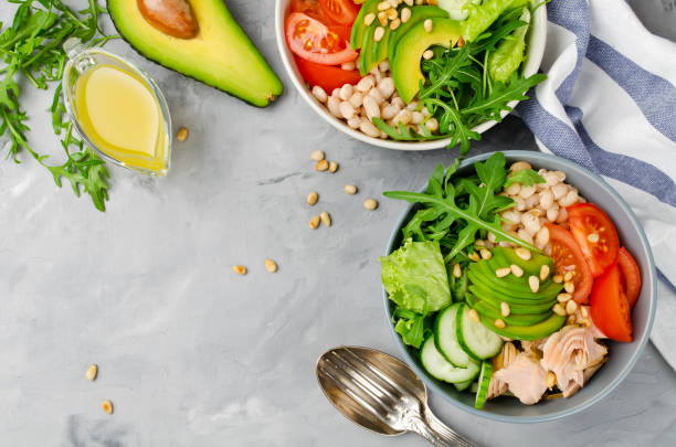 istock Salmon with white bean, tomatoes, cucumbers, avocado and arugula salad 974265826