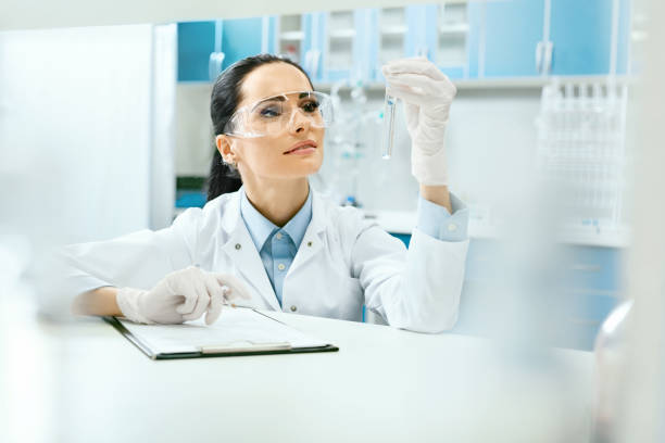 istock Scientific Laboratory. Female Scientist With Laboratory Glass. 974273618