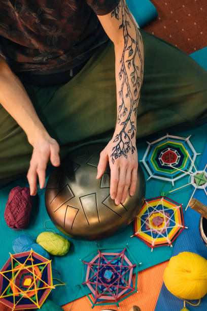 istock Male playing tank drum and practice yoga 974274178