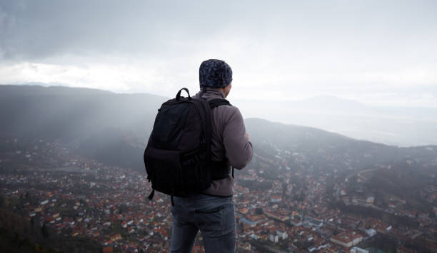 istock Hiker with backpack above the city 974274190