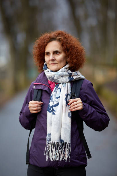 istock Woman with backpack in the park 974274196
