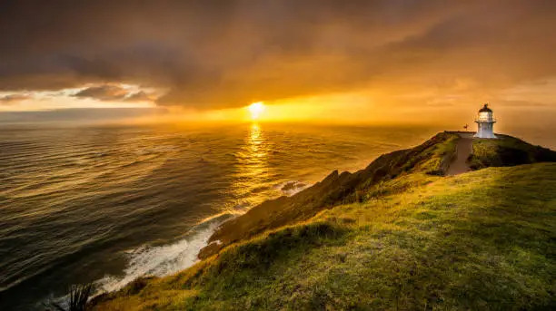 The sun sets on Cape Reinga, northernmost point of New Zealand, and a place of great spiritual significance