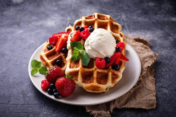 Belgium waffles with berries and ice cream. Selective focus