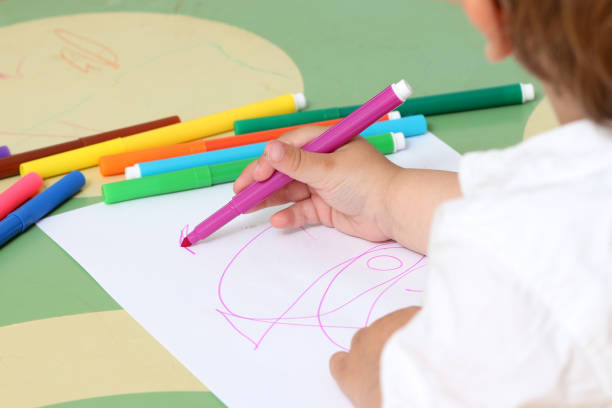 istock hand of a child who draws 974305654