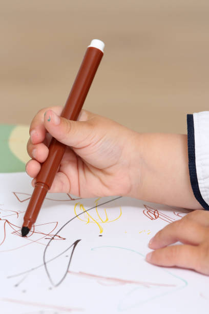 istock hand of a child who draws 974305664