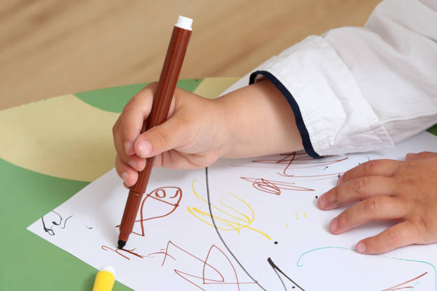 istock hand of a child who draws 974305738