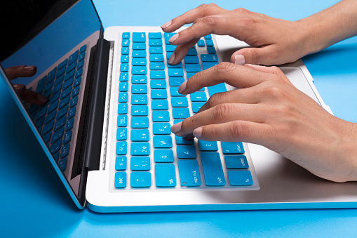 Blue Keyboard Concept with woman hand