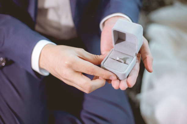 istock Man open a diamond ring box for marry his girlfriend. 974316696