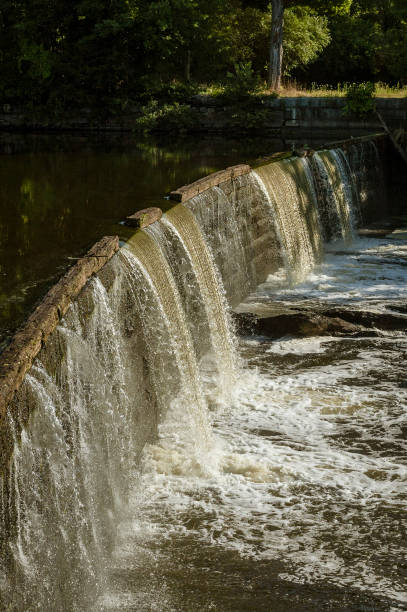 istock Water cascading down small waterfall on Blackstone River 974316850