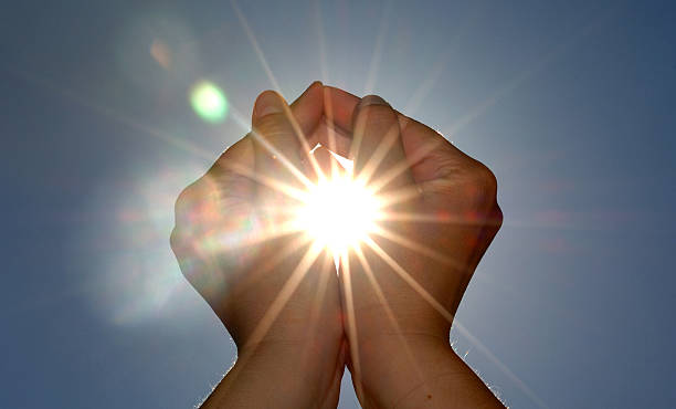 istock Looking up at two hands cupping the sun 97432040
