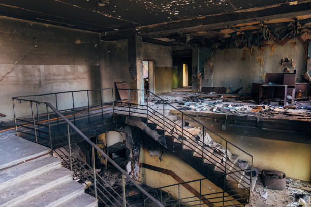 Burned interiors after fire in industrial or office building. Walls and staircase in black soot Burned interiors after fire in industrial or office building. Walls and staircase in black soot. damaged stock pictures, royalty-free photos & images