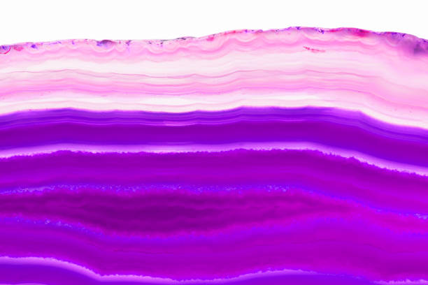 istock Abstract background - purple triped agate slice mineral isolated on white background 974326572