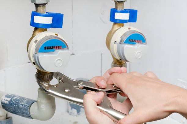 istock Technician installs a new water meter with wrench 974329258