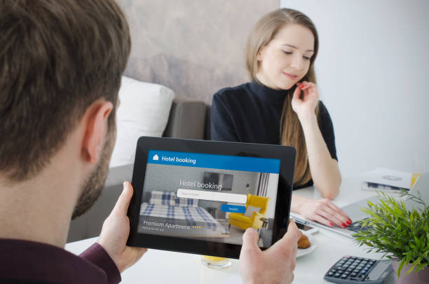 istock Couple booking hotel room on tablet. 974330042