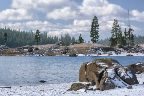 istock Snowy mountain Lake with Trees Under Cloudy Sky 974346134