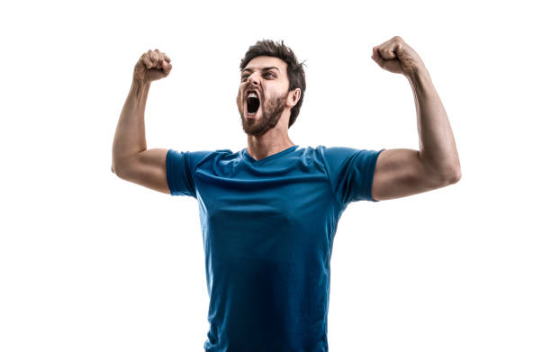 istock Male athlete / fan in blue uniform celebrating on white background 974359018