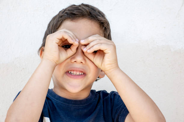 istock Smiling boy did fingers like binoculars 974359786
