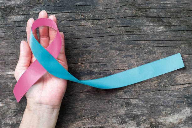 Pink blue ribbon awareness (isolated with clipping path) bow color for newborn birth defect, Sudden Infant Death Syndrome (SIDS), pregnancy Loss on helping hand Pink blue ribbon awareness (isolated with clipping path) bow color for newborn birth defect, Sudden Infant Death Syndrome (SIDS), pregnancy Loss on helping hand defeat stock pictures, royalty-free photos & images