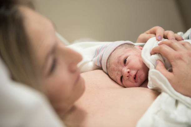 istock Child looking at mother for the first time after birth 974363450