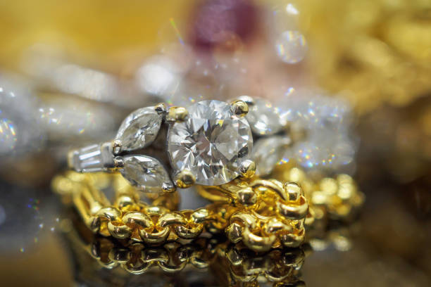 istock Luxury gold Jewelry diamond rings with reflection on black background 974363668