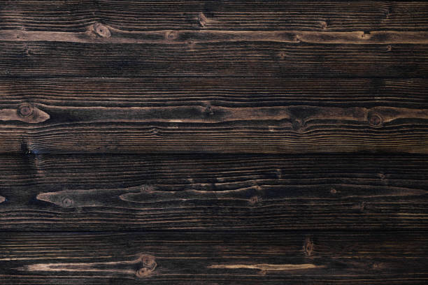 istock Dark brown wood texture with natural striped pattern background 974363992