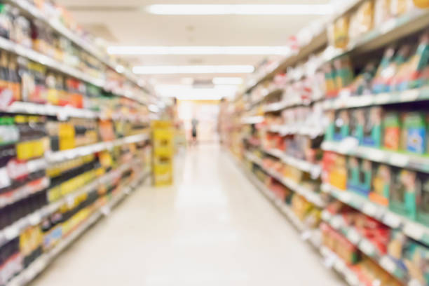 istock supermarket aisle with product on shelves blurred background 974385242