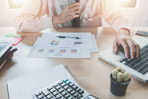 Business man working with digital tablet computer and smart phone and laptop with financial business strategy layer effect on wooden desk as concept Business man working with digital tablet computer and smart phone and laptop with financial business strategy layer effect on wooden desk as concept smart phone telephone research tax stock pictures, royalty-free photos & images